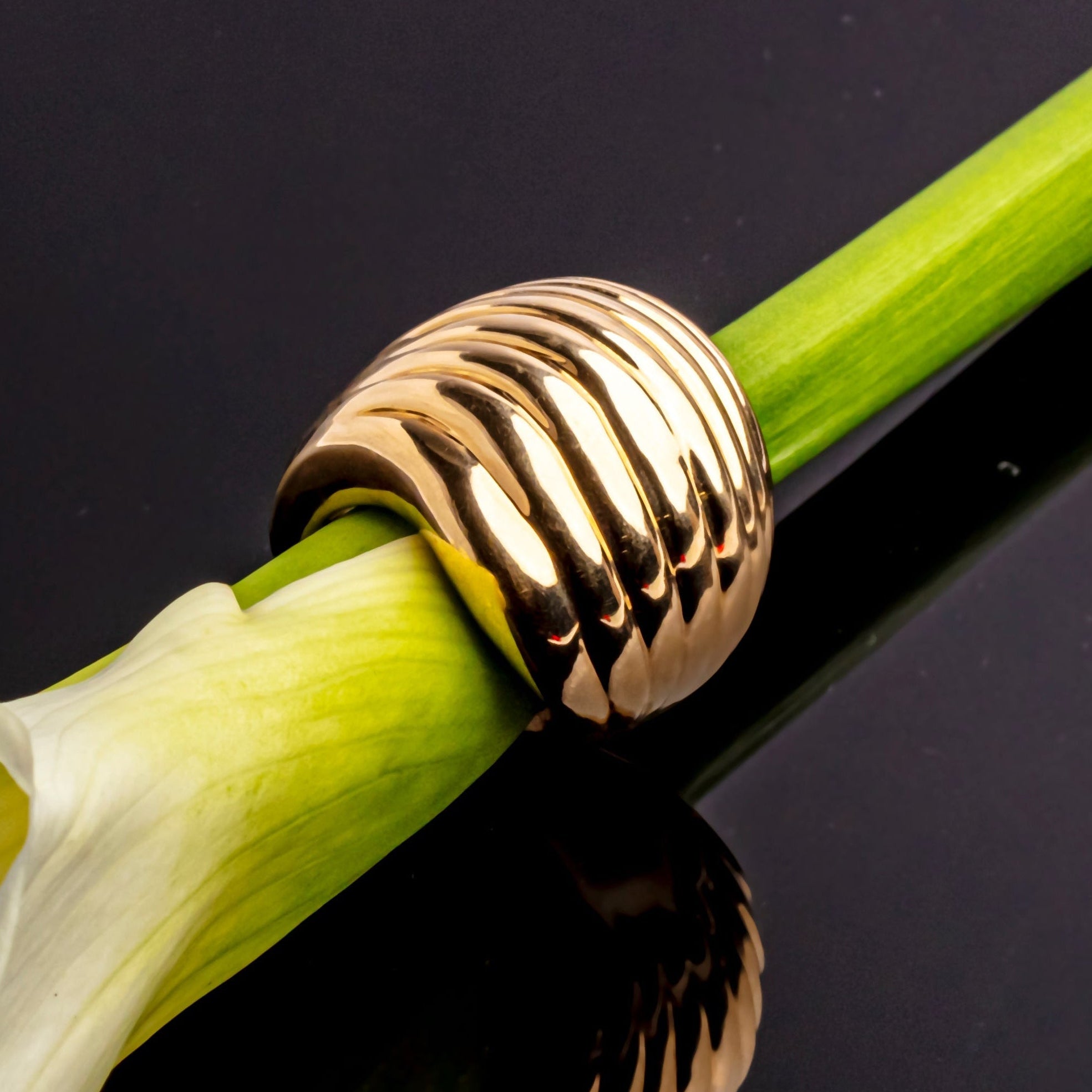 Gold plated wave sculptural ring with fluid curved design and polished finish