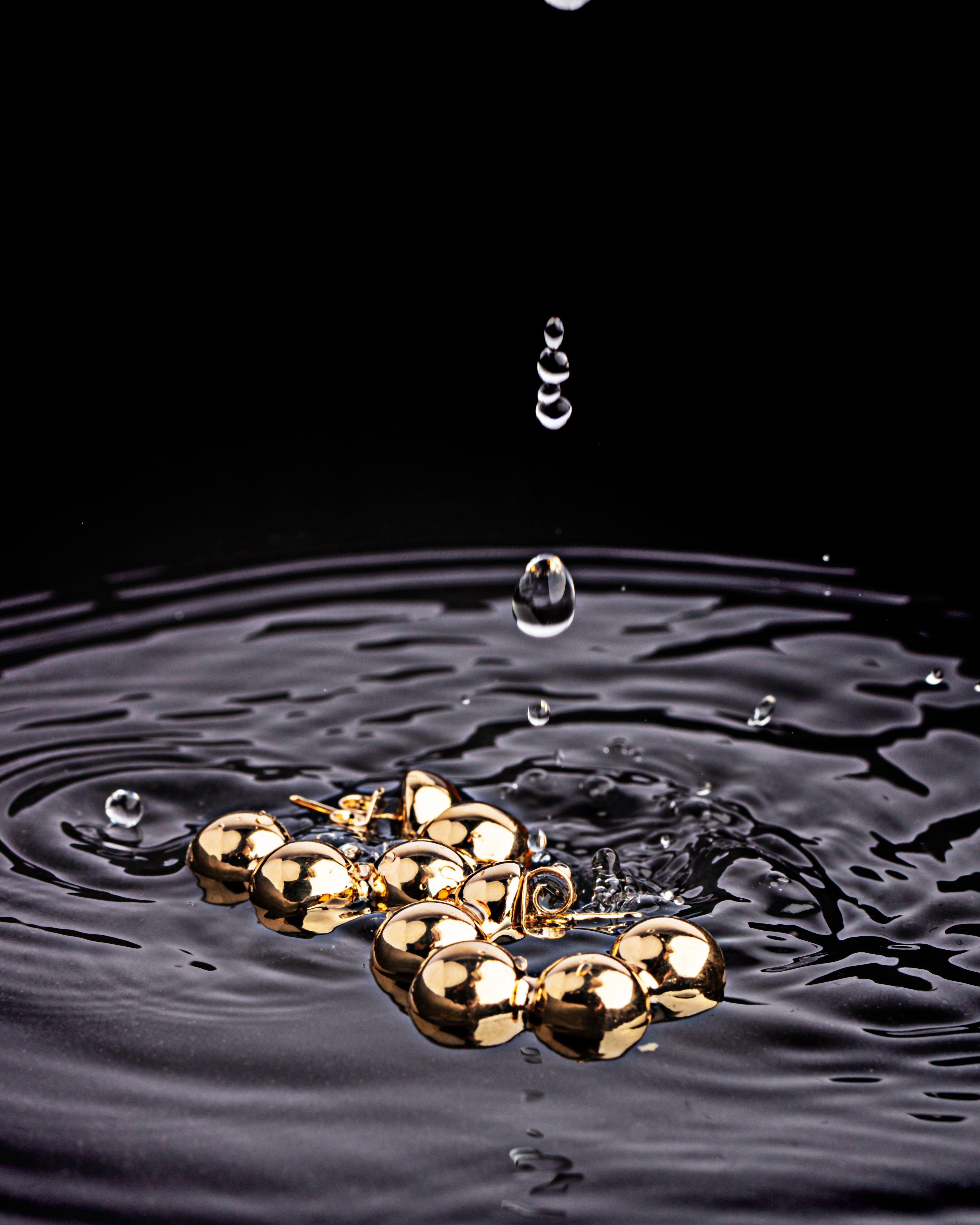 Gold plated hoop earrings with beaded link design and articulated structure
