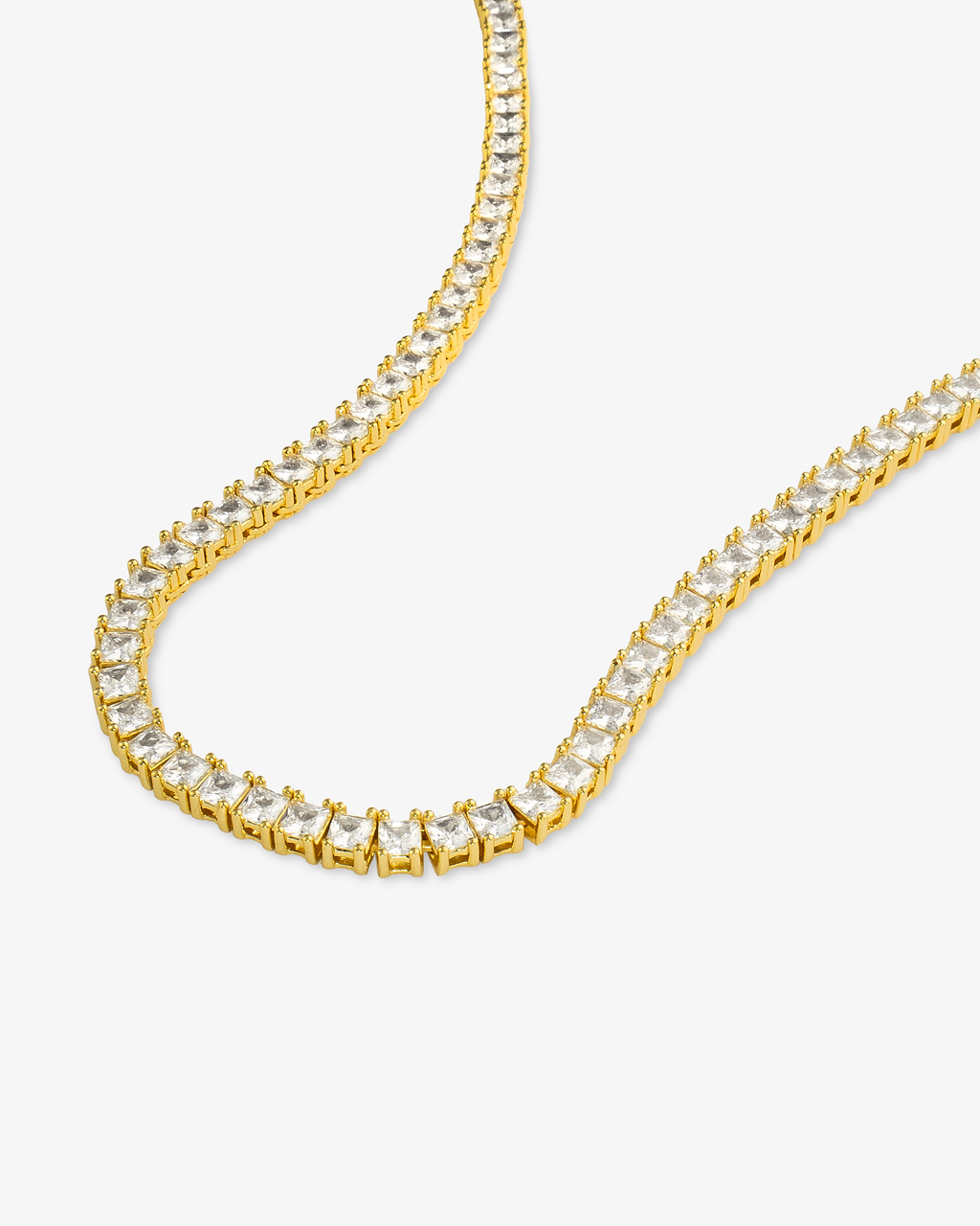 Gold square simulated diamond tennis necklace, alone product shot laid in a curved squiggle shape.
