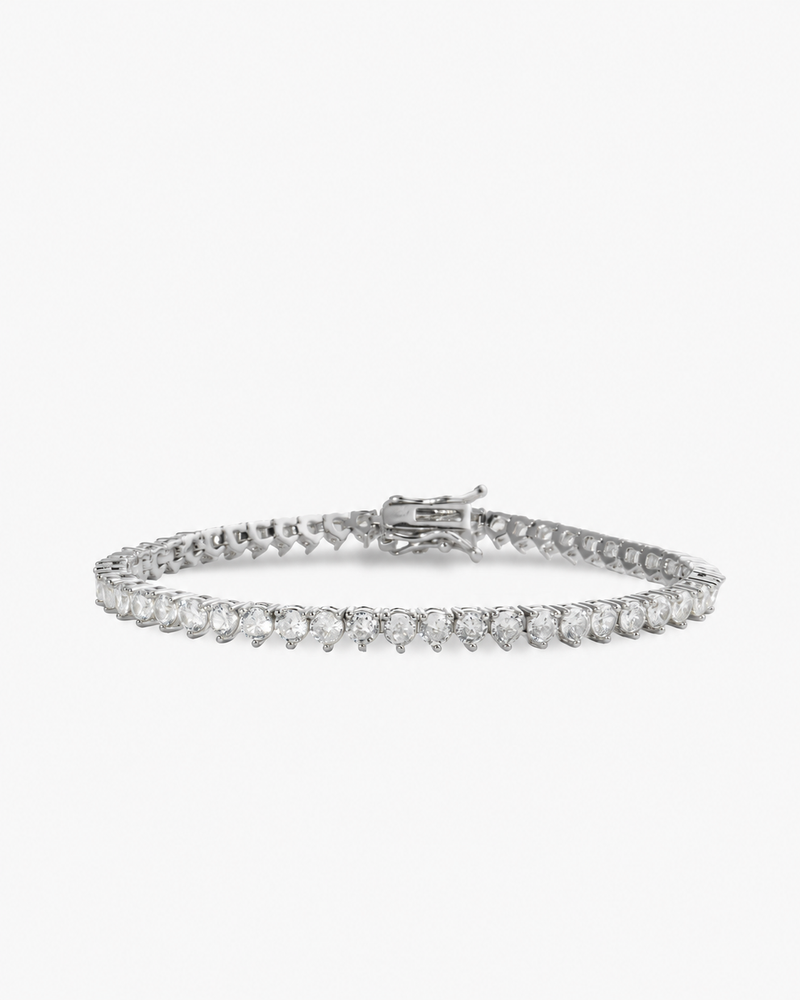 Silver three-prong simulated diamond tennis bracelet, alone product shot on a plain background.