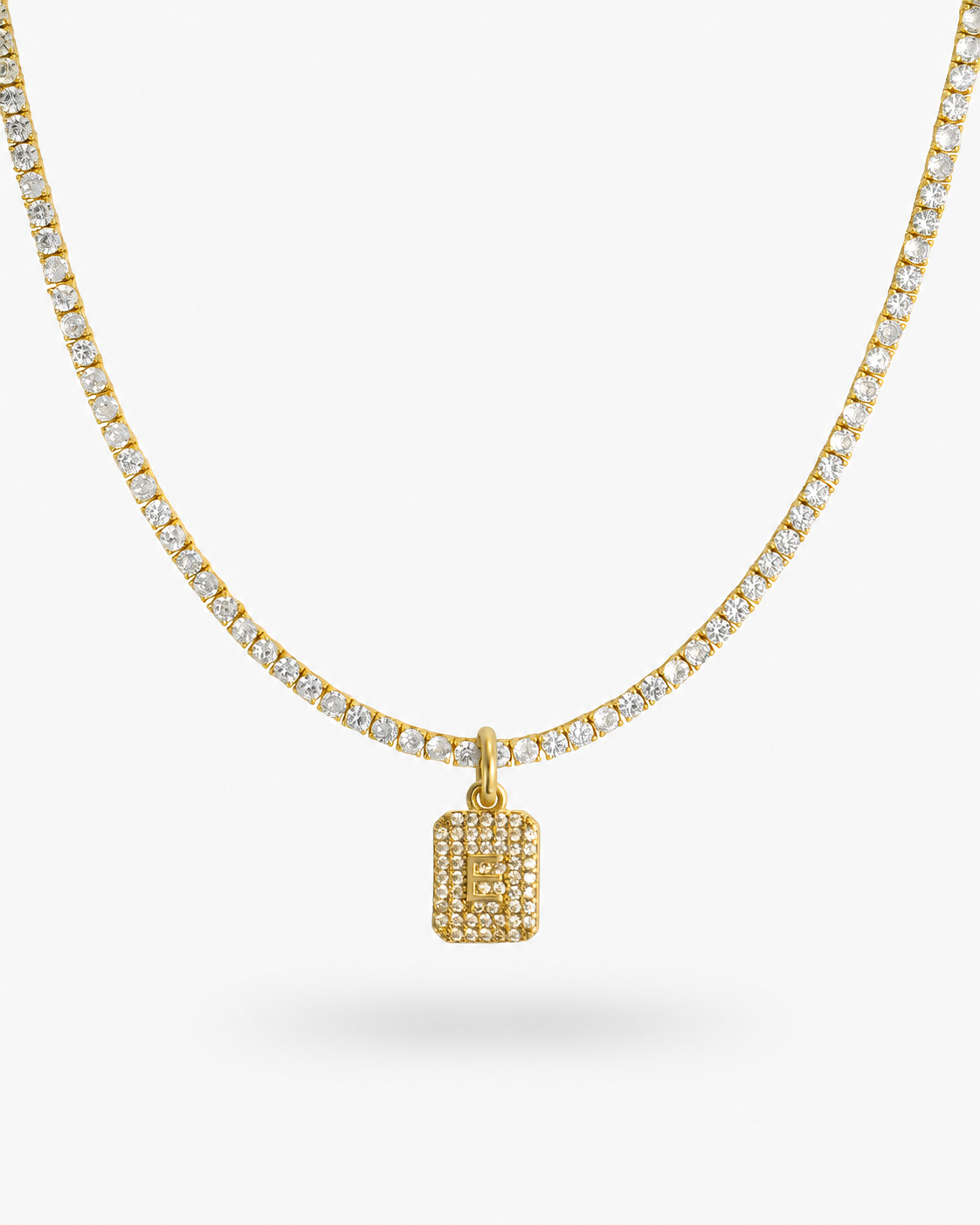 Gold tennis necklace with a pave simulated diamond initial letter pendant, alone product shot on a plain background.