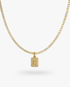 Gold tennis necklace with a pave simulated diamond initial letter pendant, alone product shot on a plain background.