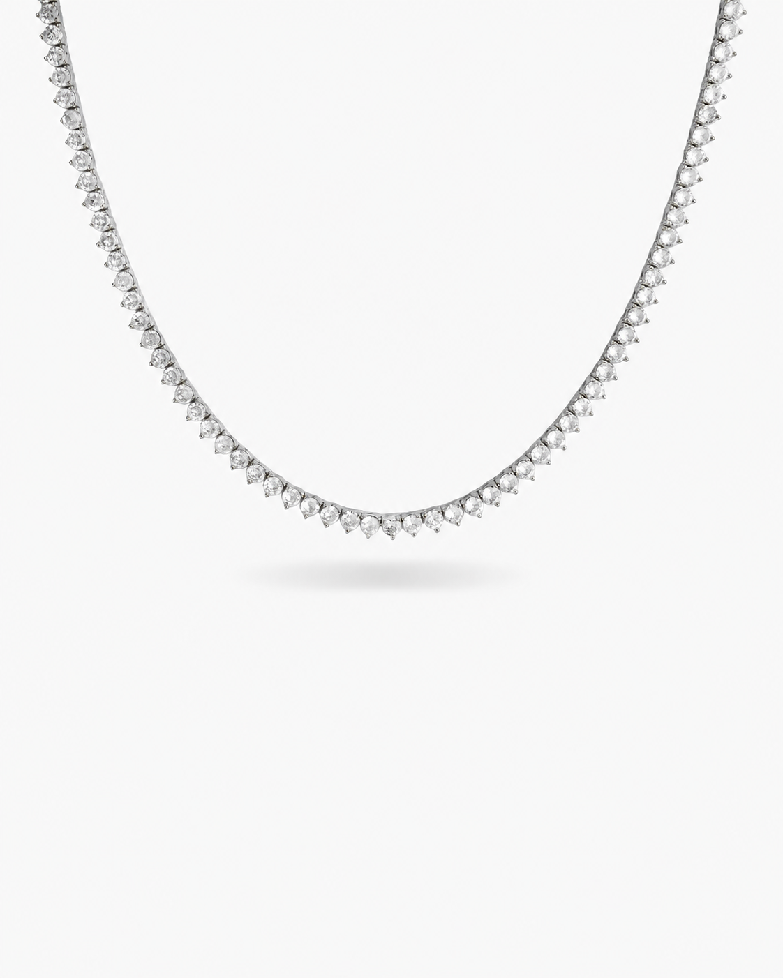 Silver three-prong tennis necklace with simulated diamond stones, alone product shot on a plain background.
