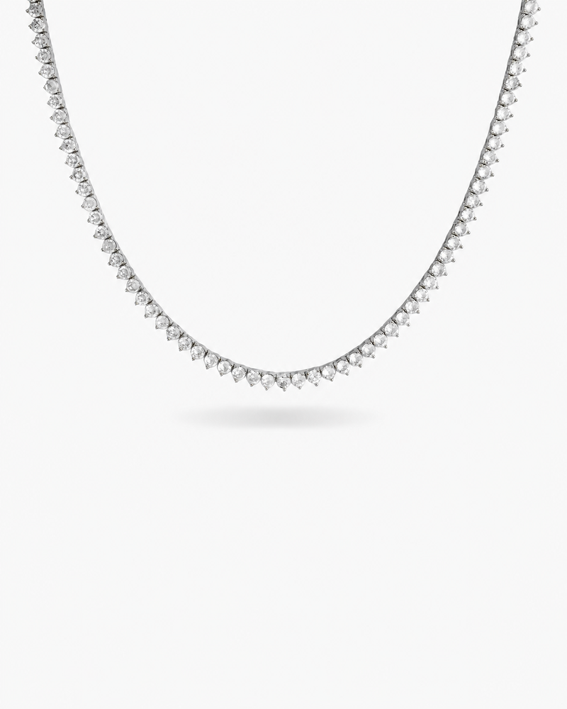 Silver three-prong tennis necklace with simulated diamond stones, alone product shot on a plain background.