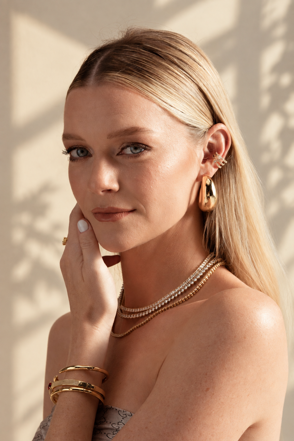 Lifestyle photo of a woman with her hand near her chin, wearing the chunky geometric ear cuff.