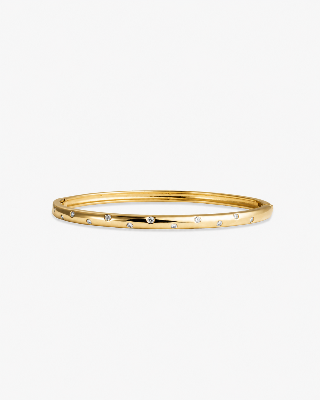 Gold slim textured bangle bracelet, alone product shot on a plain background.