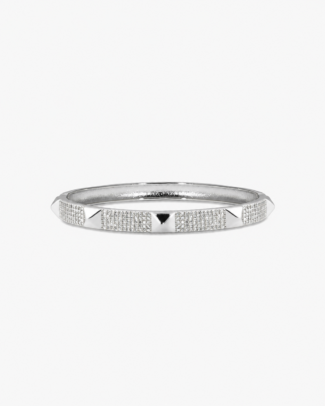 Silver textured bangle bracelet, alone product shot on a plain background.