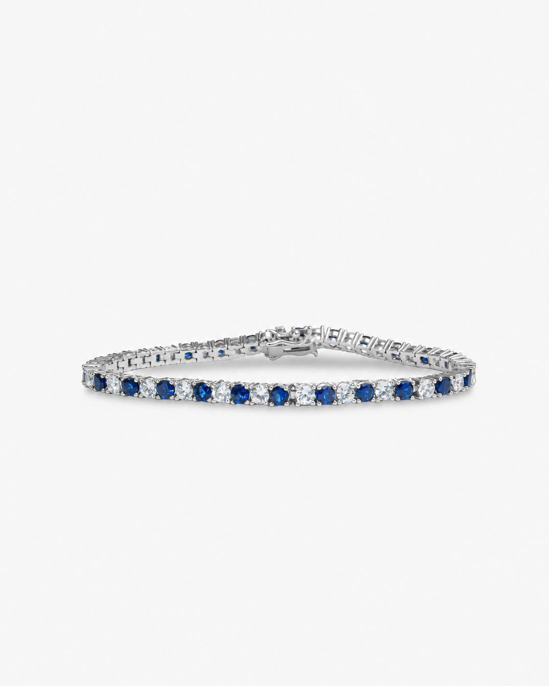 Silver tennis bracelet with blue colored stone detailing, alone product shot on a plain background.