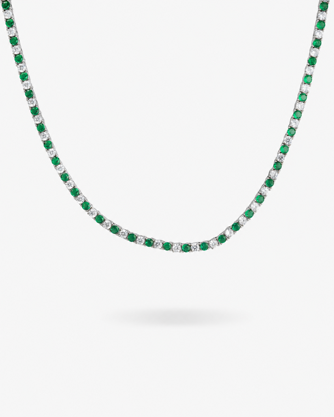 Silver tennis necklace with green colored simulated diamond stones, alone product shot on a plain background.