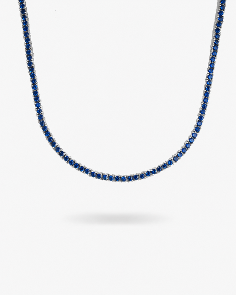 Silver tennis necklace with multicolor simulated diamond stones, alone product shot on a plain background.