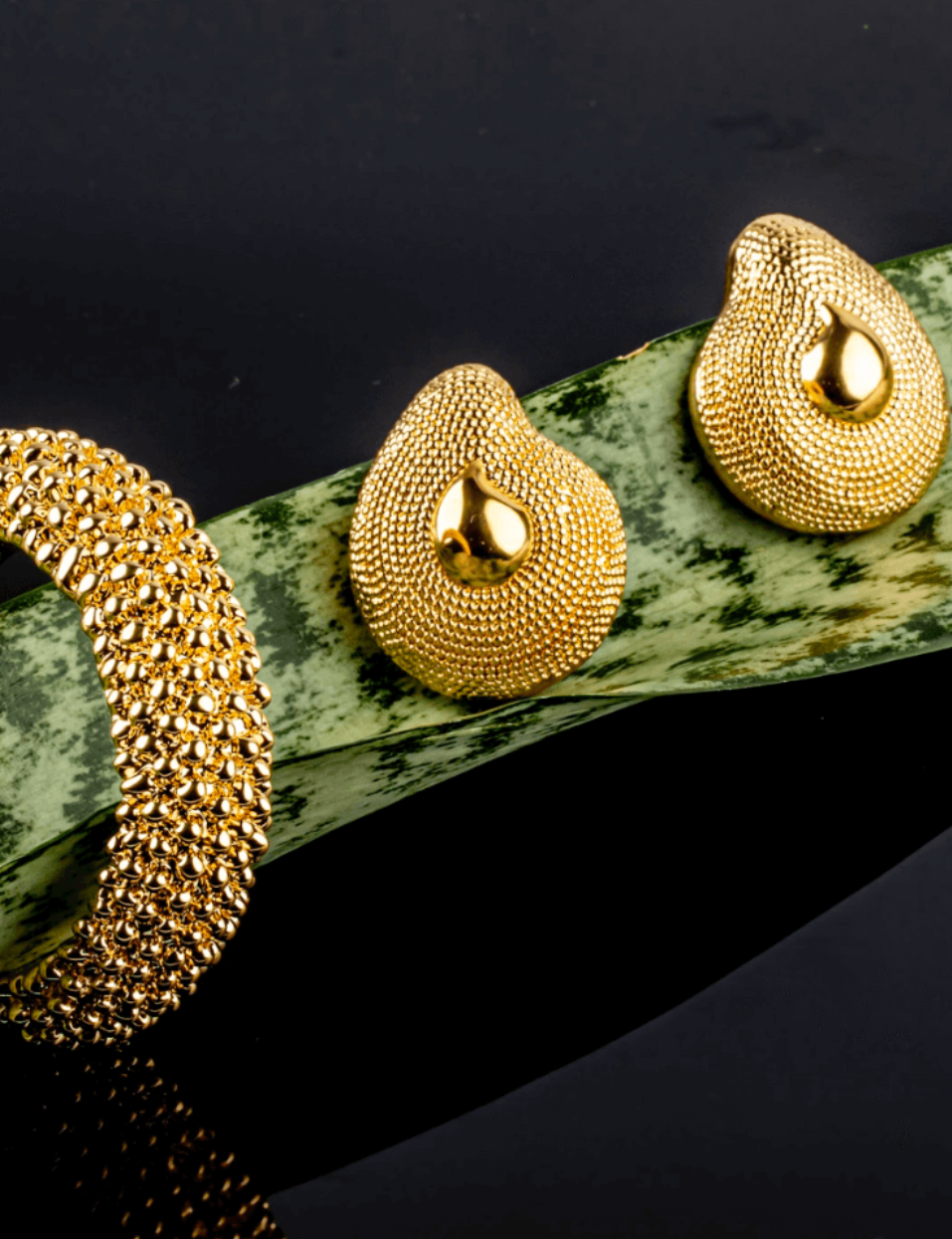 Gold plated textured dome earrings with rounded sculptural shape and asymmetric design, 40mm by 33mm