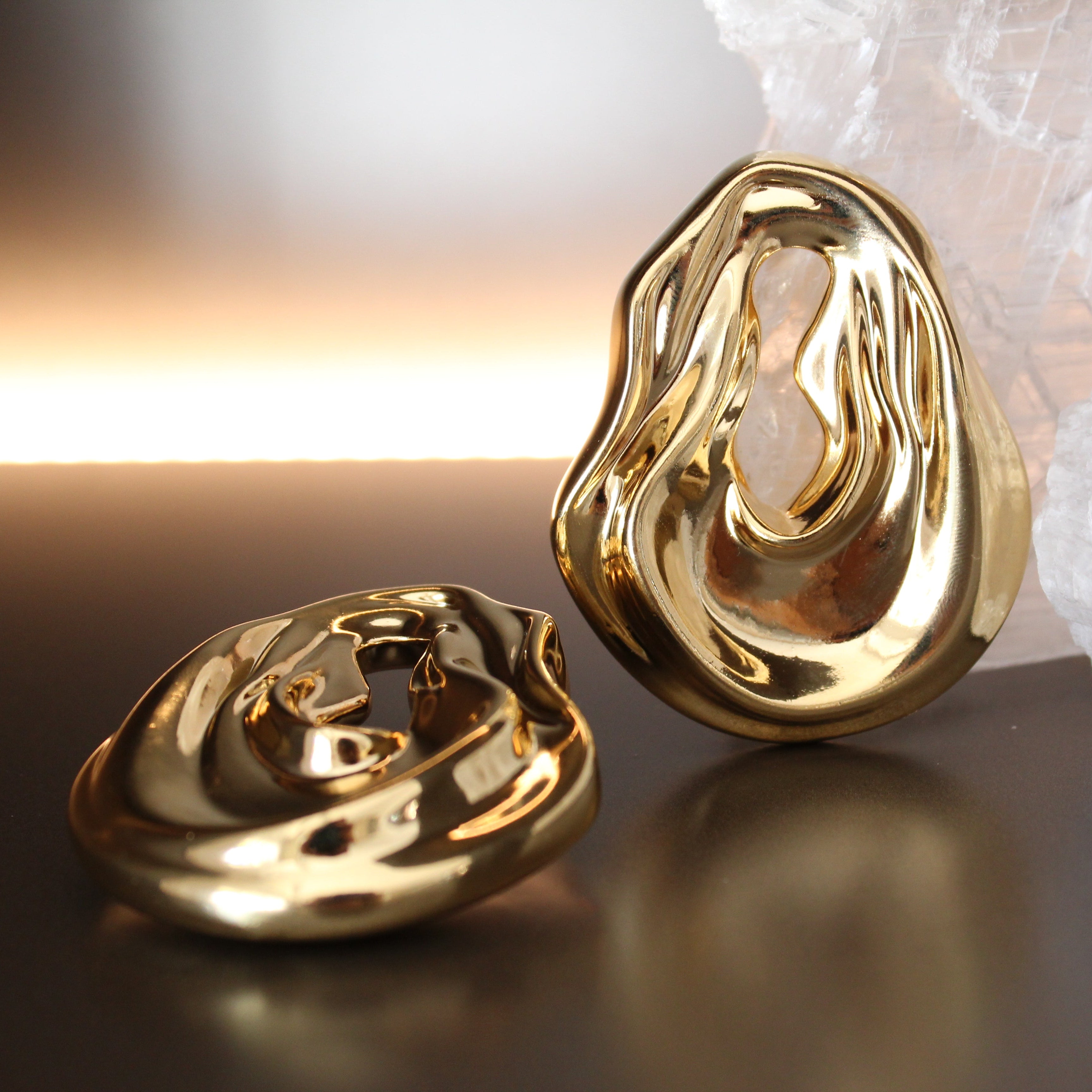 Gold plated abstract oval earrings with large sculptural asymmetric design and polished finish, 61mm by 51mm