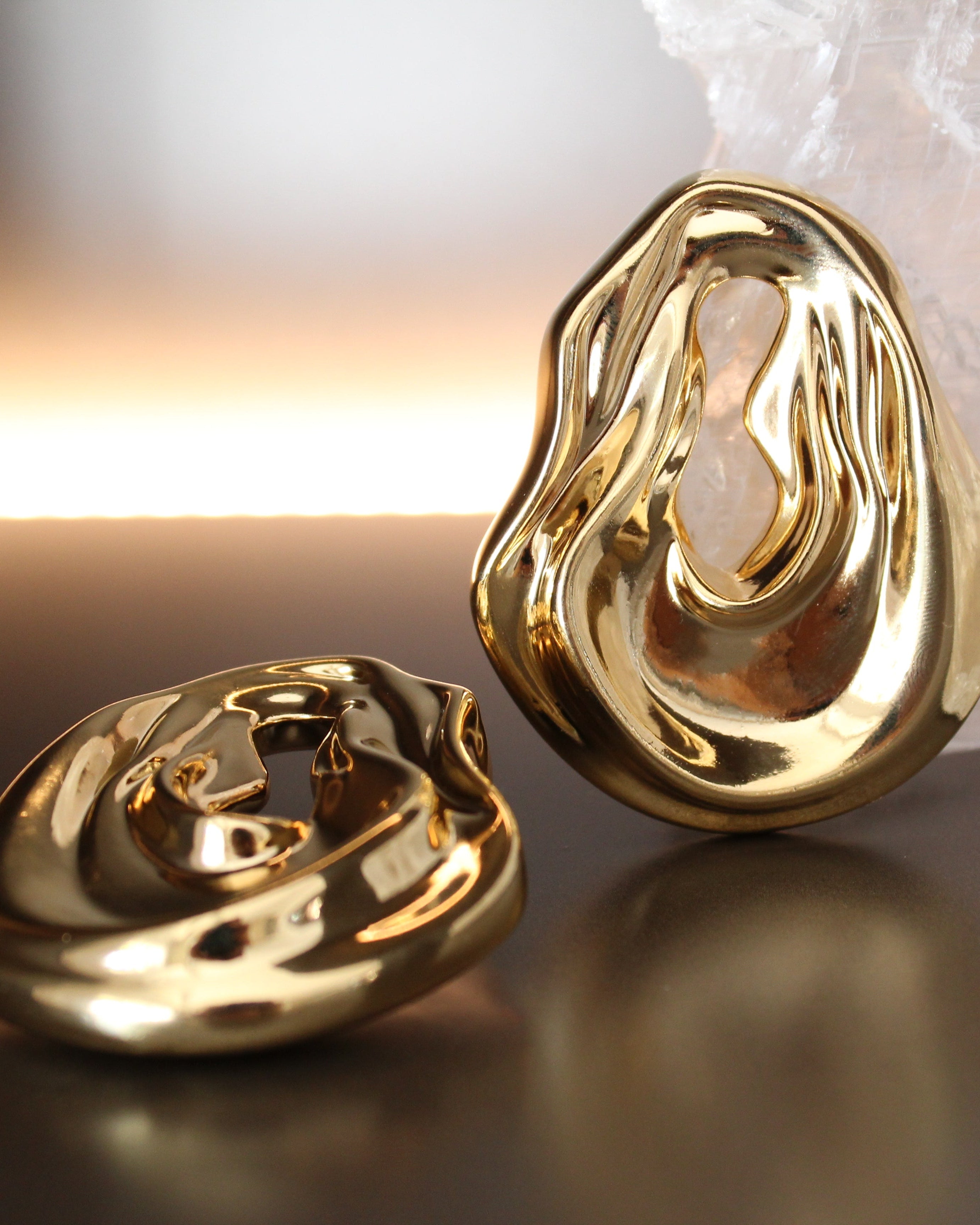 Gold plated abstract oval earrings with large sculptural asymmetric design and polished finish, 61mm by 51mm