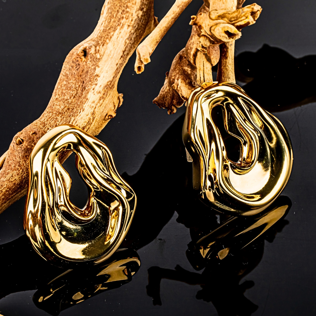 Gold plated abstract oval earrings with large sculptural asymmetric design and polished finish, 61mm by 51mm