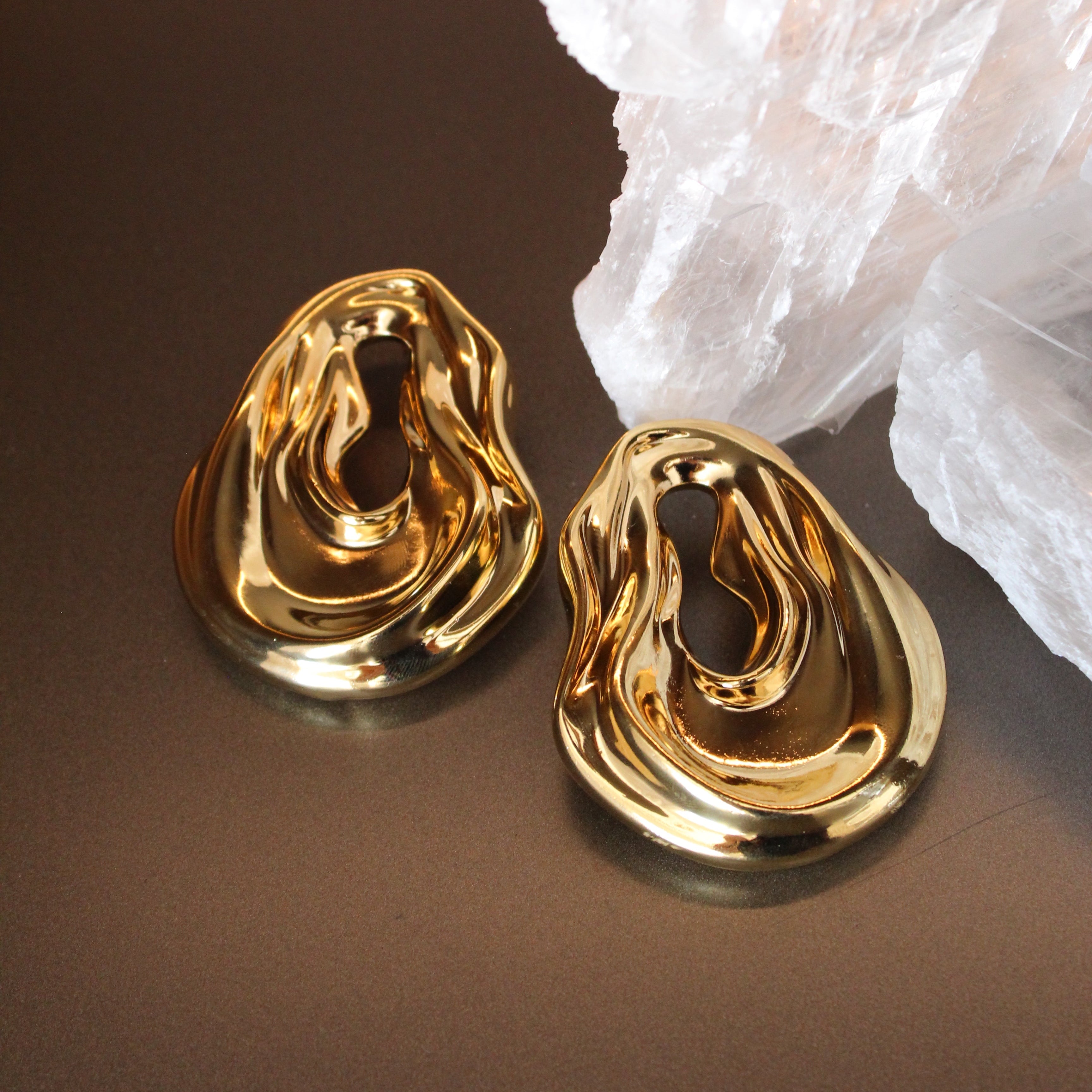 Gold plated abstract oval earrings with large sculptural asymmetric design and polished finish, 61mm by 51mm