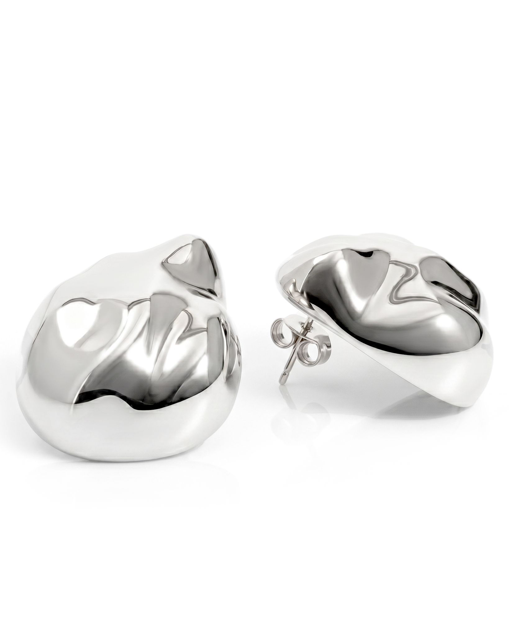 Dome earrings available in gold plated and rhodium plated finishes with dented sculptural texture