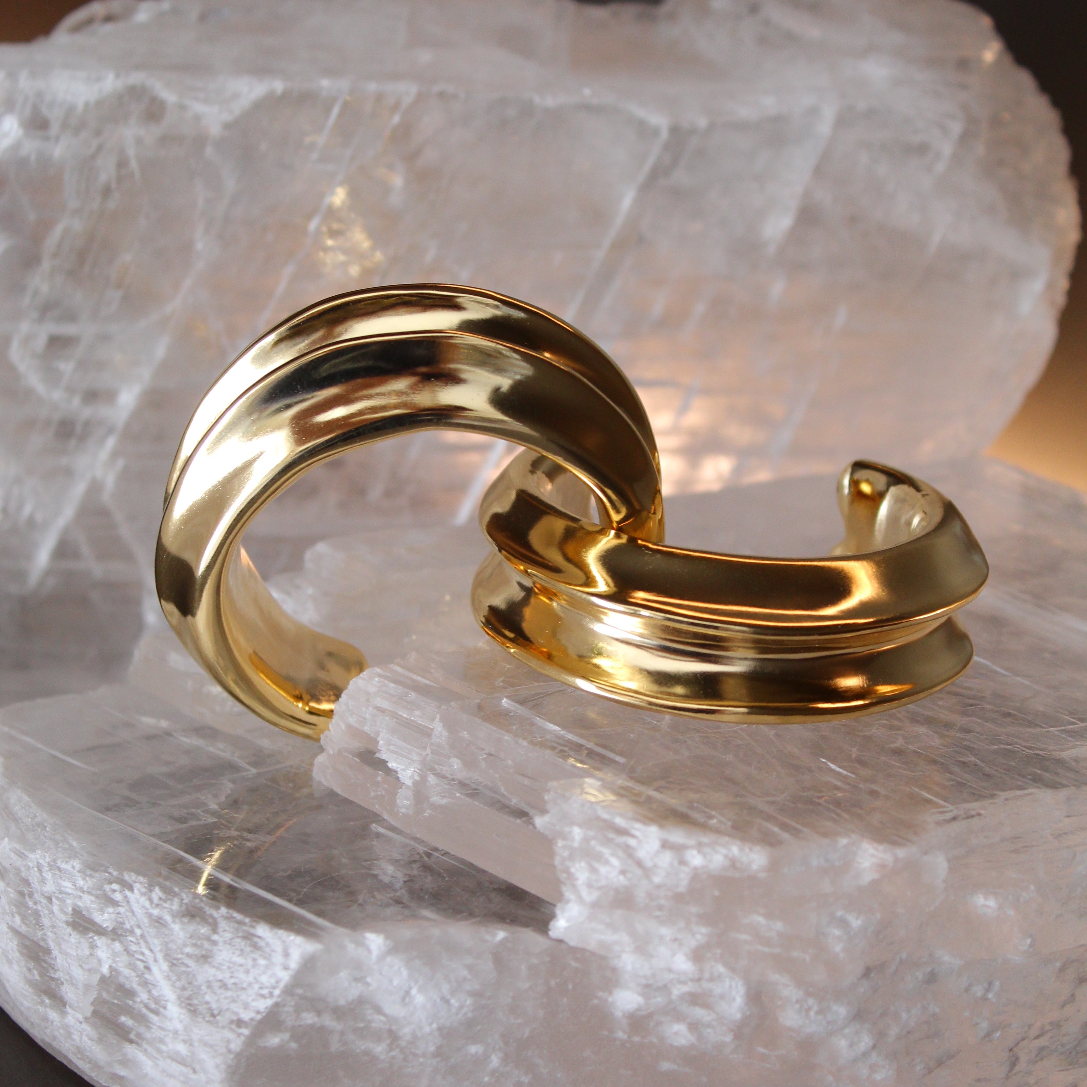 Gold plated cuff bracelet with smooth polished surface and sculptural open design, 24mm width