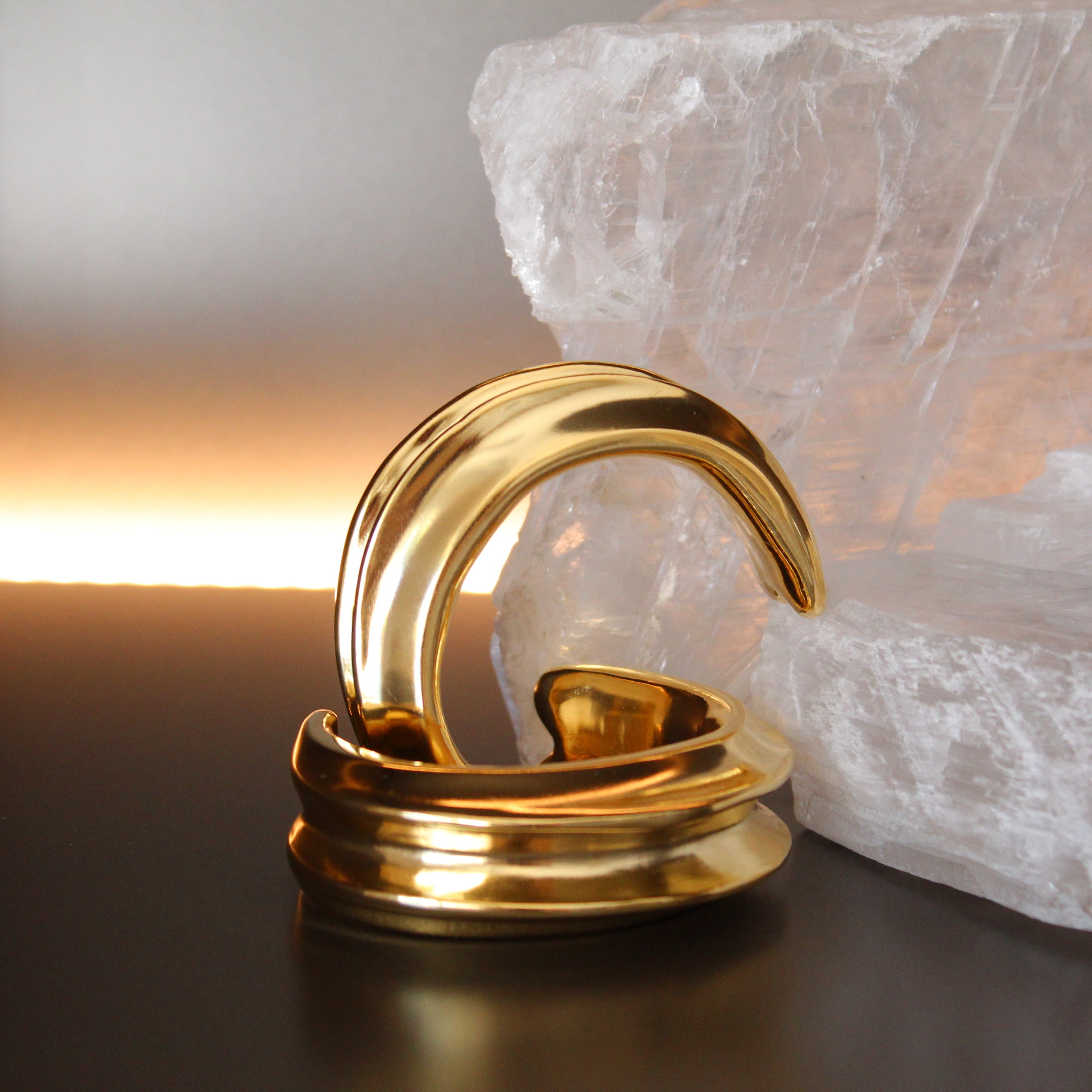 Gold plated cuff bracelet with smooth polished surface and sculptural open design, 24mm width