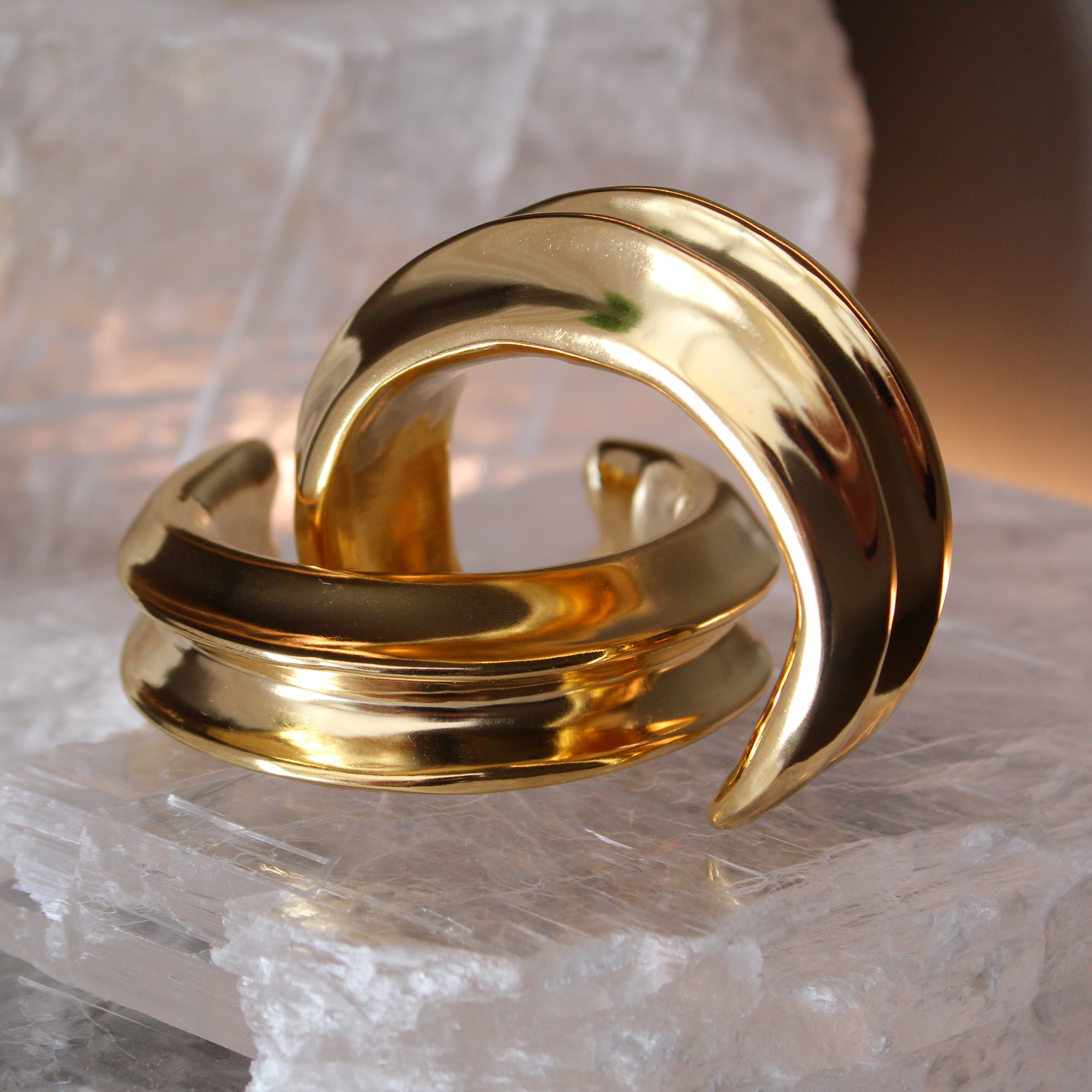 Gold plated cuff bracelet with smooth polished surface and sculptural open design, 24mm width