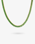 Gold tennis necklace with green baguette-cut simulated diamond stones, alone product shot on a plain background.