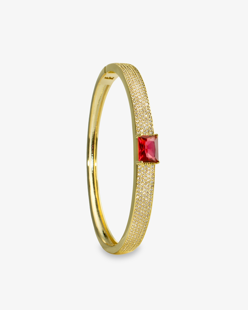 Gold open cuff bangle bracelet with a single red simulated diamond stone, alone product shot shown vertically.