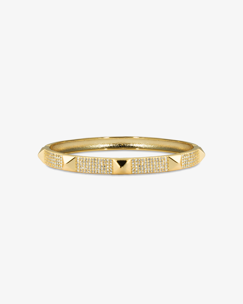 Gold textured bangle bracelet, alone product shot on a plain background.