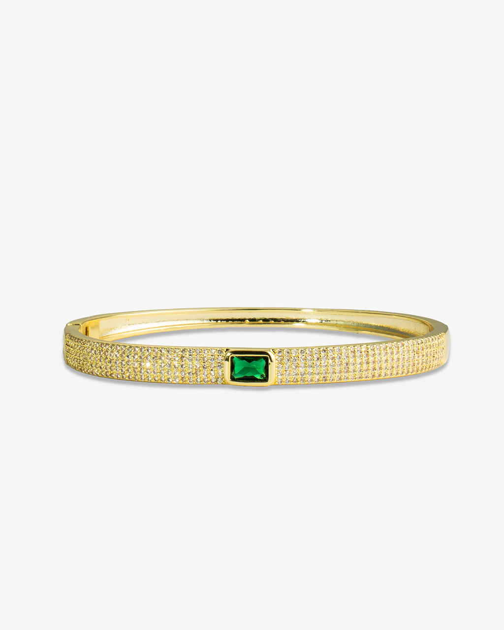 Gold textured bangle bracelet with a green simulated diamond accent stone, alone product shot on a plain background.