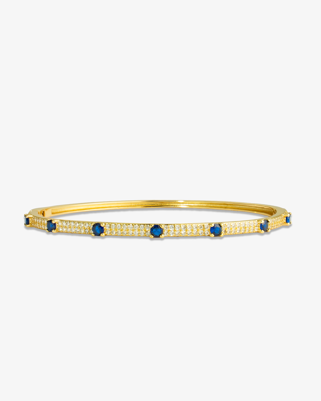 Gold thin bangle bracelet with blue simulated diamond stone detailing, alone product shot on a plain background.