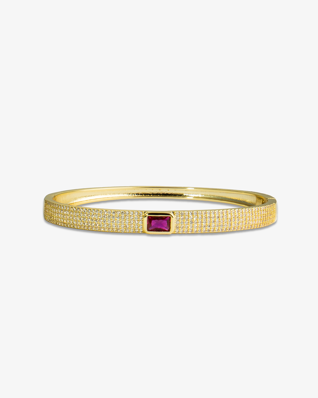 Gold textured bangle bracelet with a pink simulated diamond accent stone, alone product shot on a plain background.