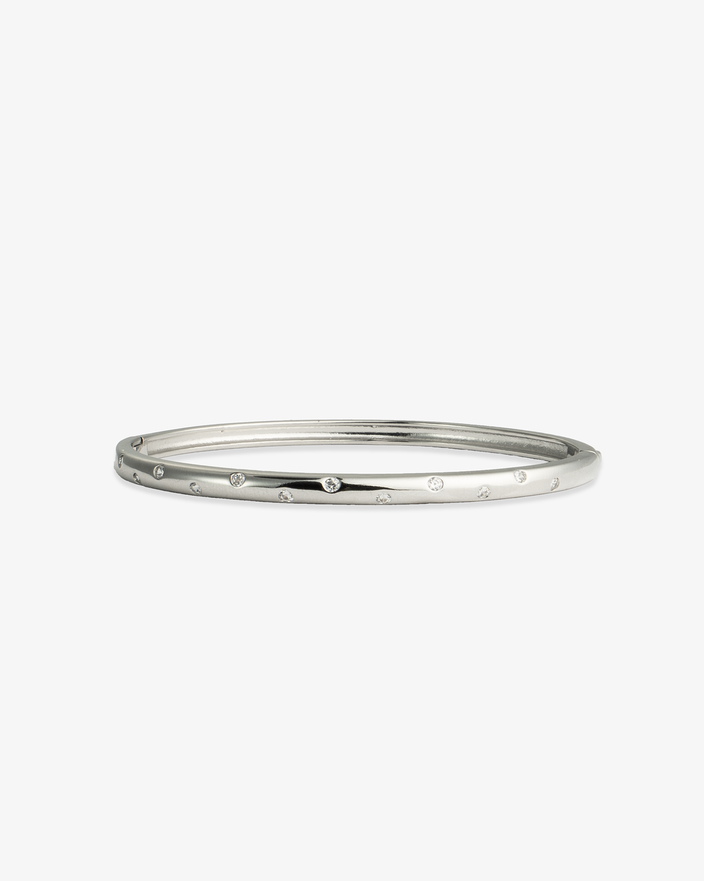 Silver slim textured bangle bracelet, alone product shot on a plain background.