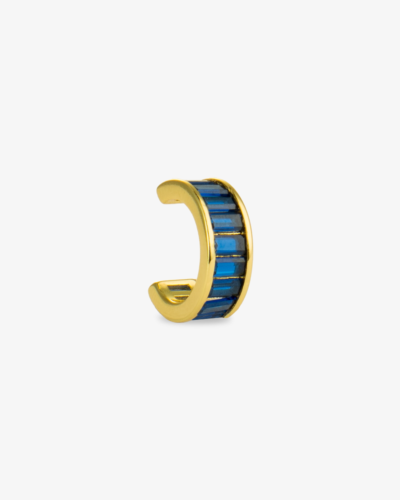 Gold ear cuff with blue baguette-cut simulated diamond stones, alone product shot on a plain background.