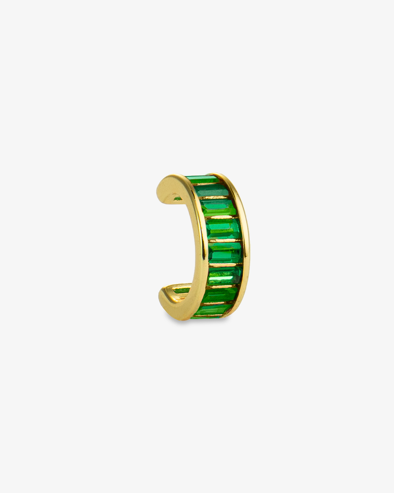 Gold ear cuff with green baguette-cut simulated diamond stones, alone product shot on a plain background.