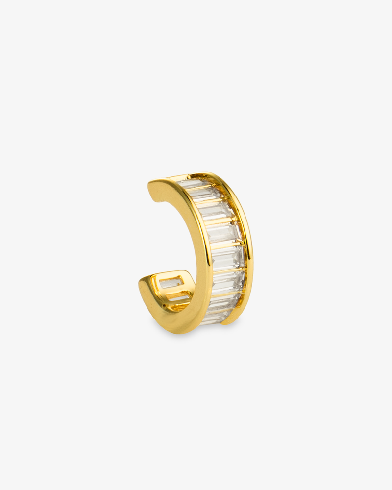 Gold ear cuff with clear baguette-cut simulated diamond stones, alone product shot on a plain background.