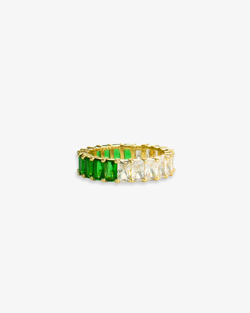 Gold eternity band ring with green simulated diamond stones, alone product shot on a plain background.