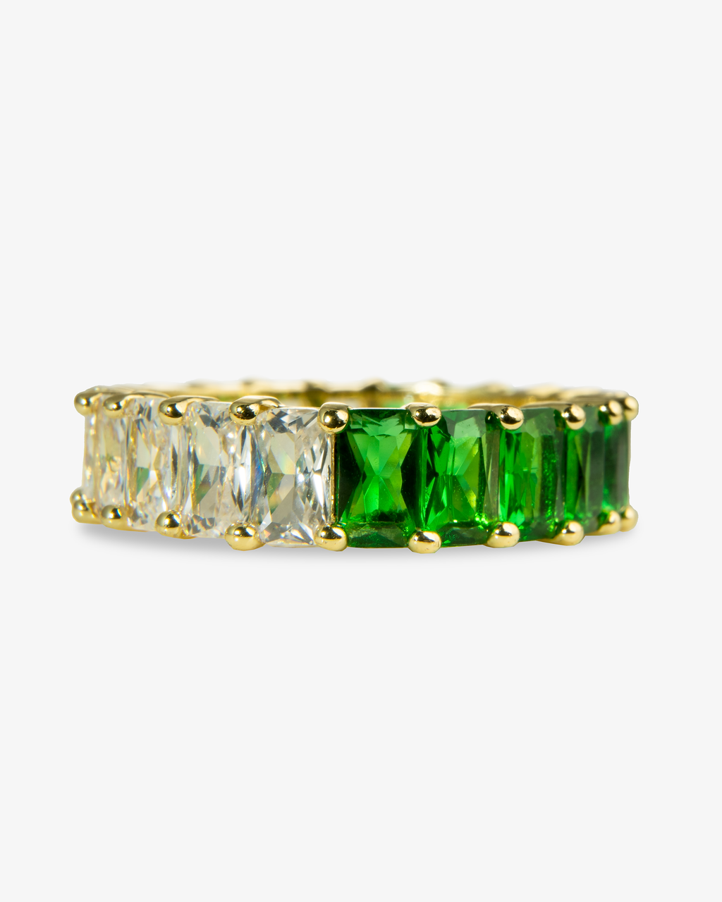 Gold eternity band ring with green and clear simulated diamond stones, alone product shot from a different angle.