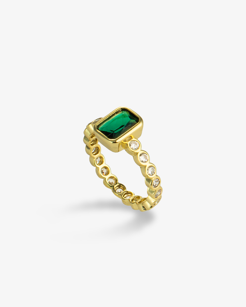 Gold ring with a green emerald-cut simulated diamond center stone and pave band, alone product shot on a plain background.
