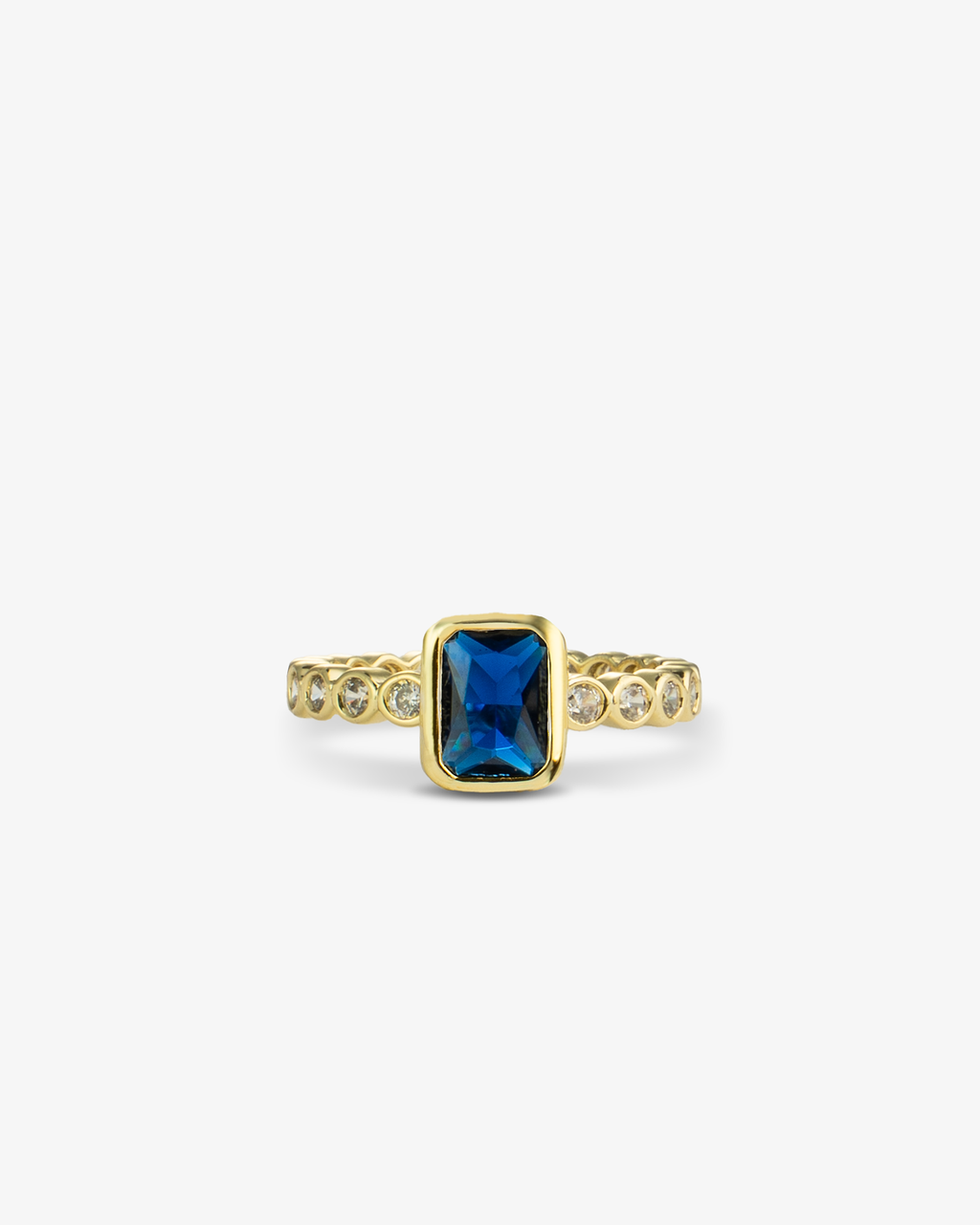 Gold ring with a teal emerald-cut simulated diamond center stone and pave band, alone close-up product shot.