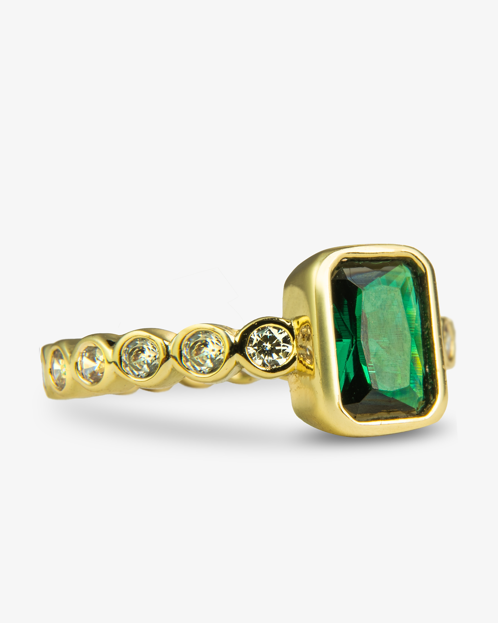 Gold ring with a blue emerald-cut simulated diamond center stone and pave band, alone close-up product shot.