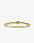 Gold three-prong simulated diamond tennis bracelet, alone product shot on a plain background.