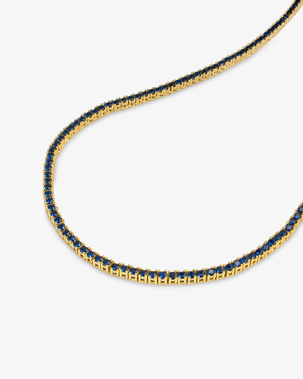 Gold tennis necklace with multicolor simulated diamond stones, alone product shot from a different angle.