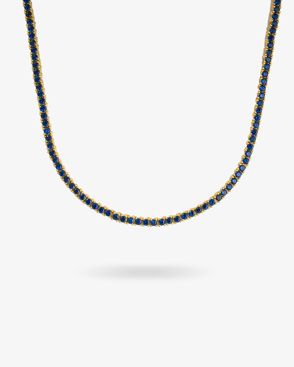 Gold tennis necklace with multicolor simulated diamond stones, alone product shot from a different angle.
