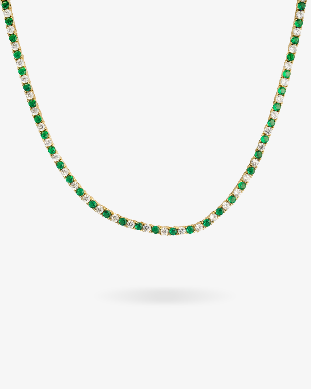 Tennis necklace with green emerald-colored simulated diamond stones, alone product shot on a plain background.