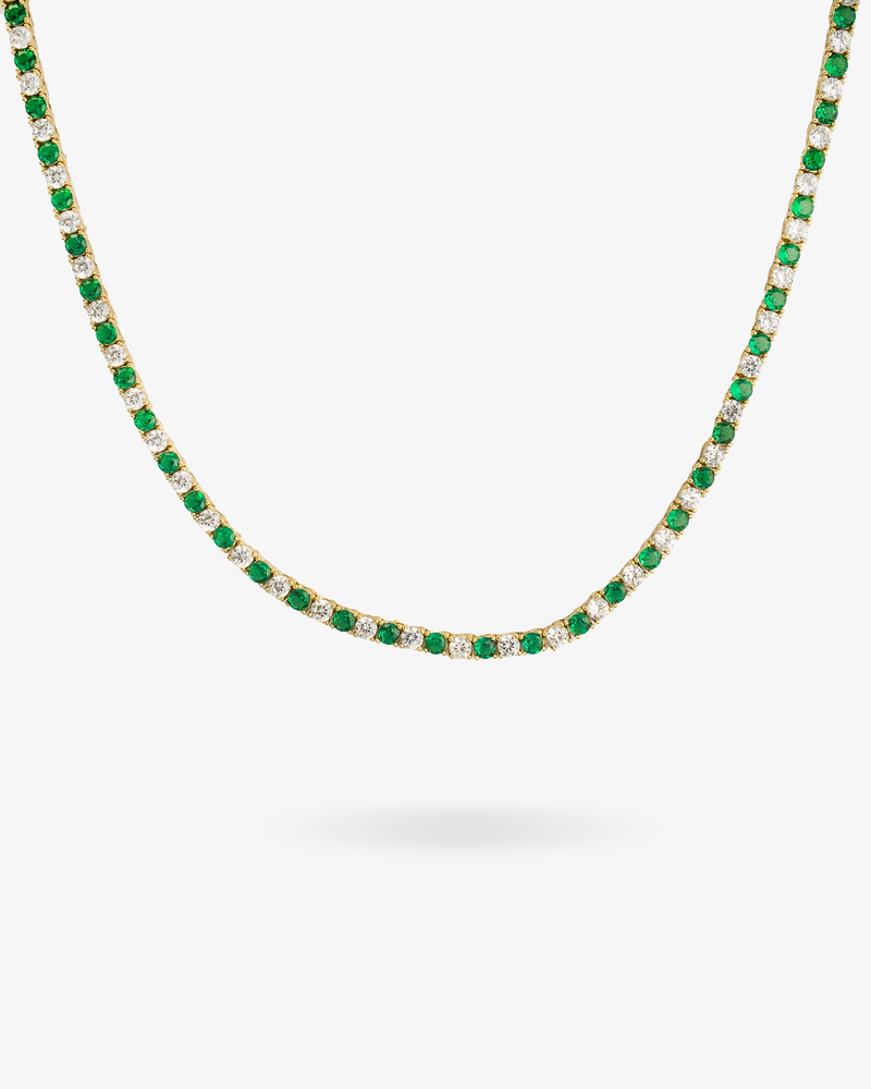 Tennis necklace with green emerald-colored simulated diamond stones, alone product shot on a plain background.