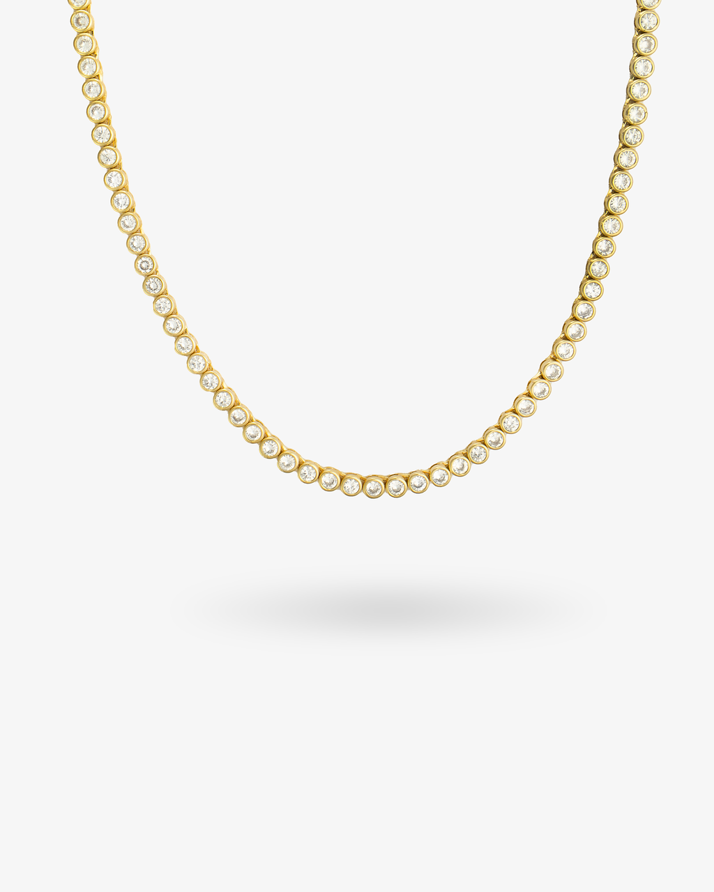 Gold round bezel-set tennis necklace, alone product shot on a plain background.