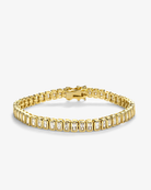 Gold emerald-cut tennis bracelet featuring rectangular clear stones in polished gold settings