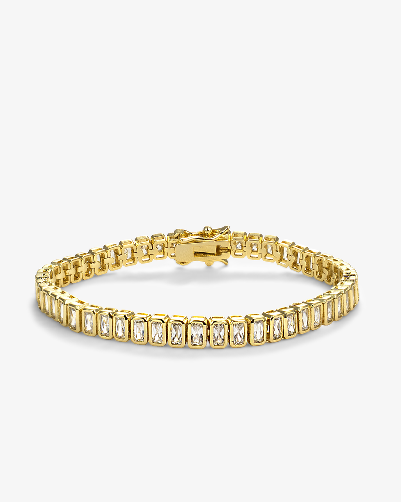 Gold emerald-cut tennis bracelet featuring rectangular clear stones in polished gold settings
