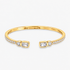 Gold open bangle bracelet with pavé simulated diamond accents at each end, alone product shot on a plain background.
