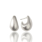 Small sculptural rhodium plated earrings with rounded molten-inspired design and polished high shine finish, 24mm diameter