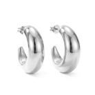 Large gold plated hoop earrings with thick sculptural curved design and polished finish, 38mm diameter