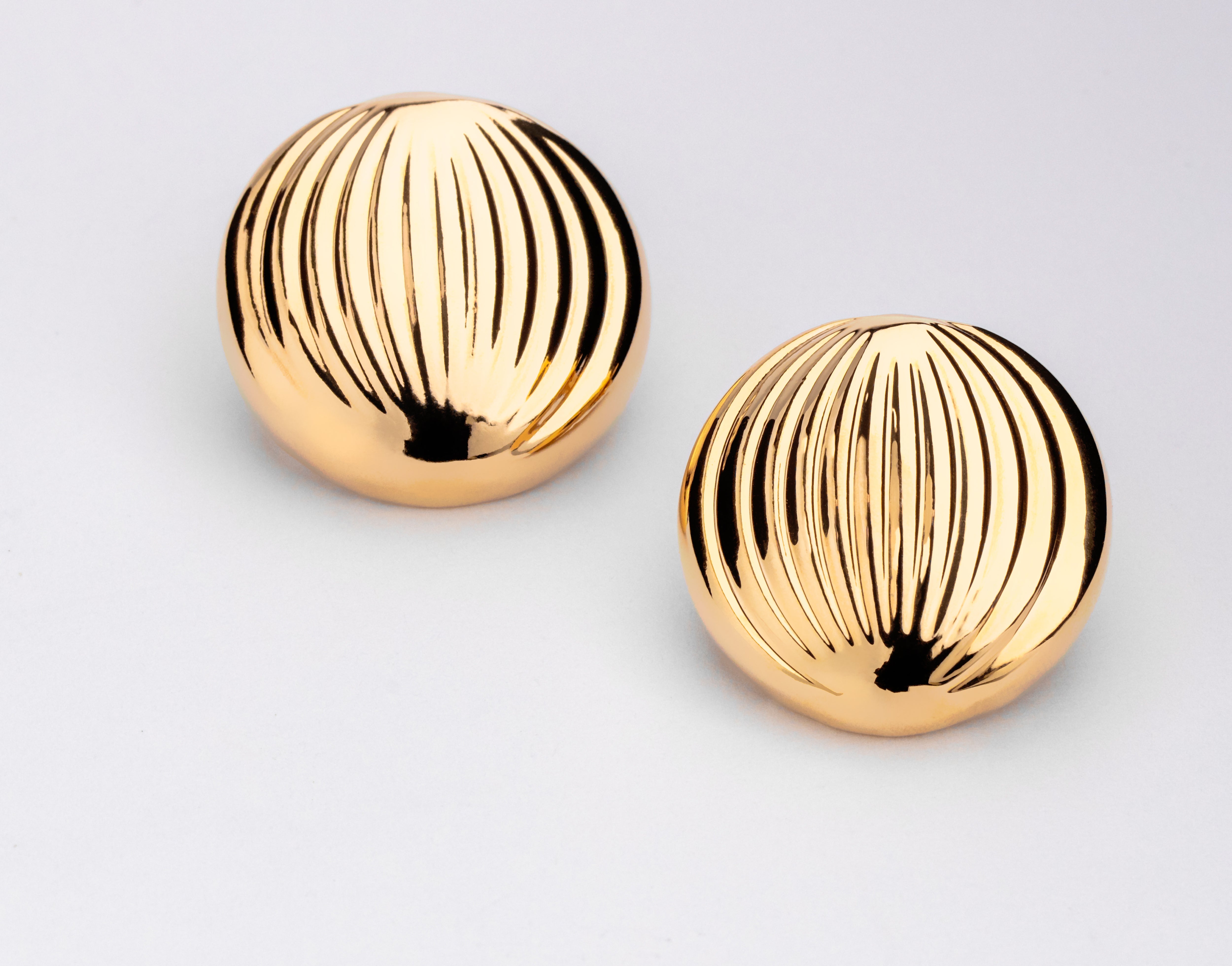 Gold plated small sculptural earrings with compact design and polished finish